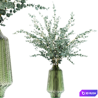 Eucalyptus branches in a green vase